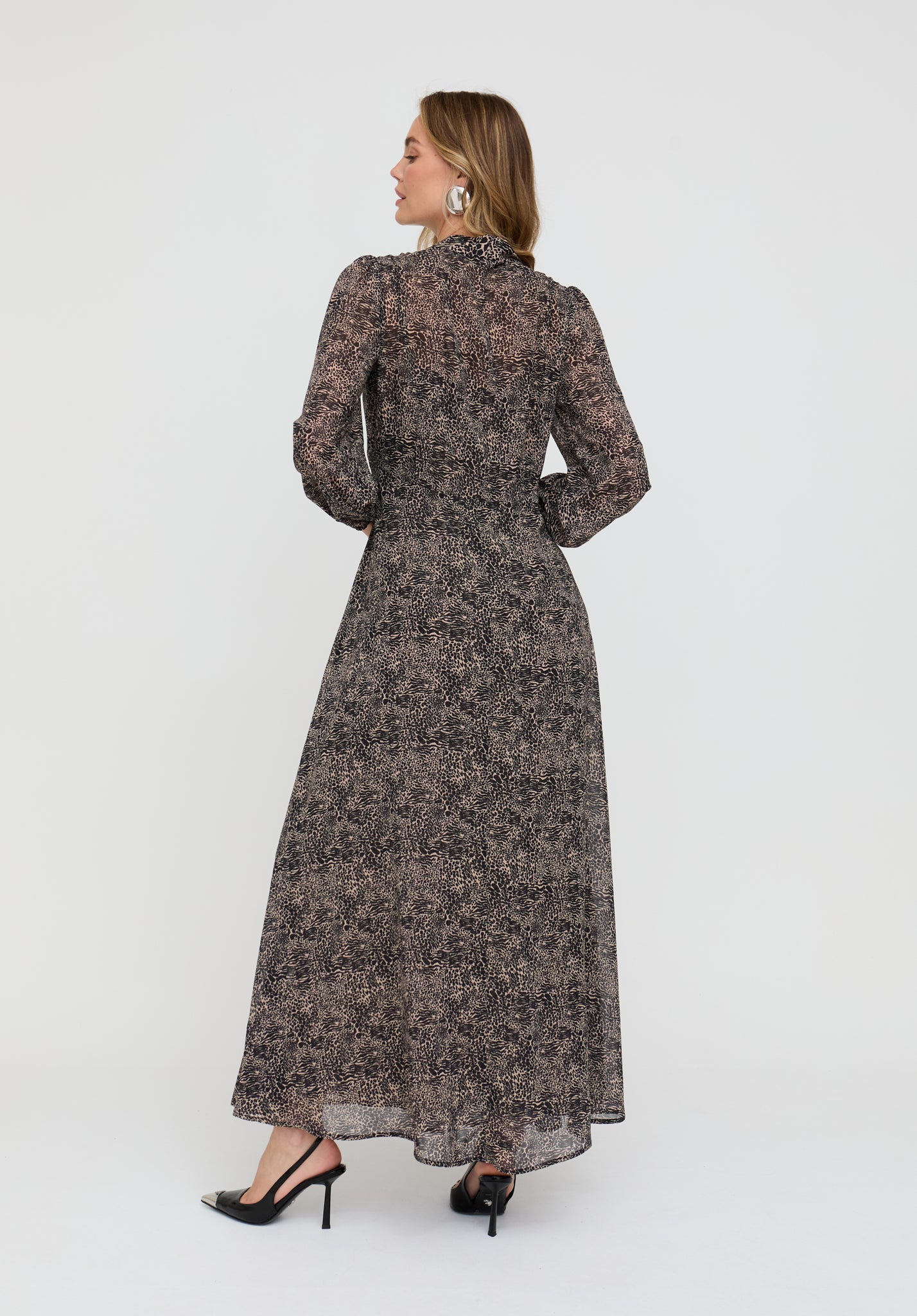 Woman wearing a long floral dress on a white background