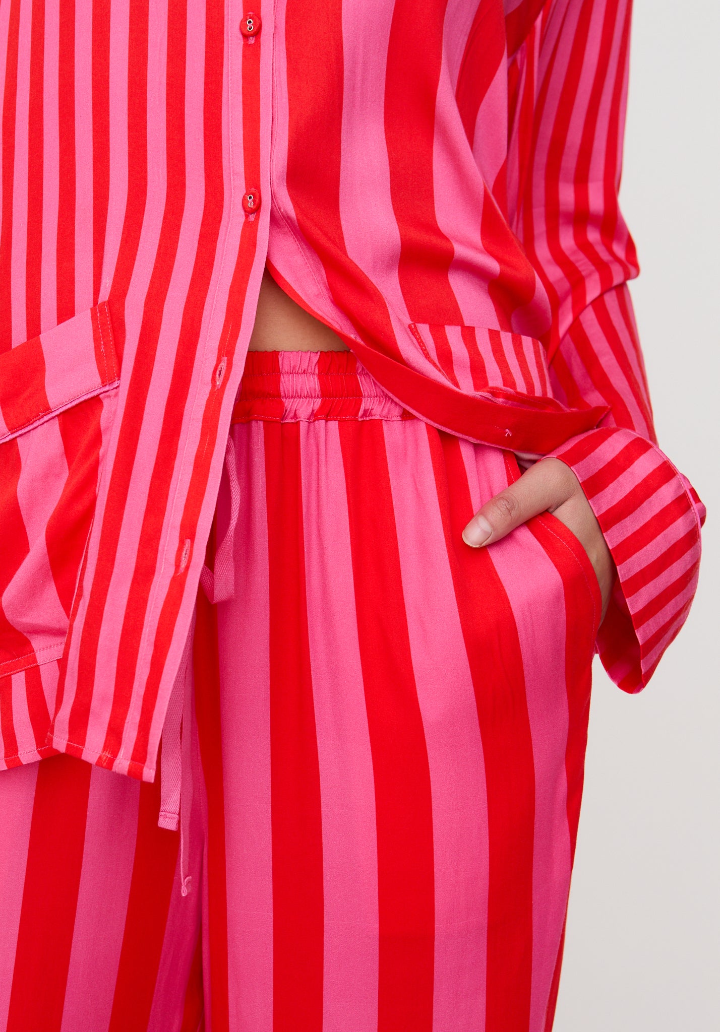 Red and pink striped outfit on a plain background