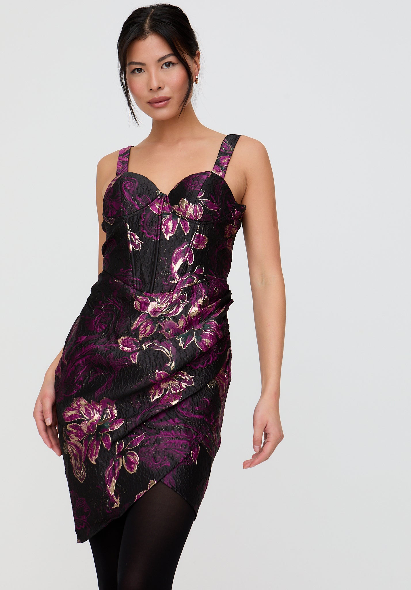 Woman wearing a black floral dress on a white background