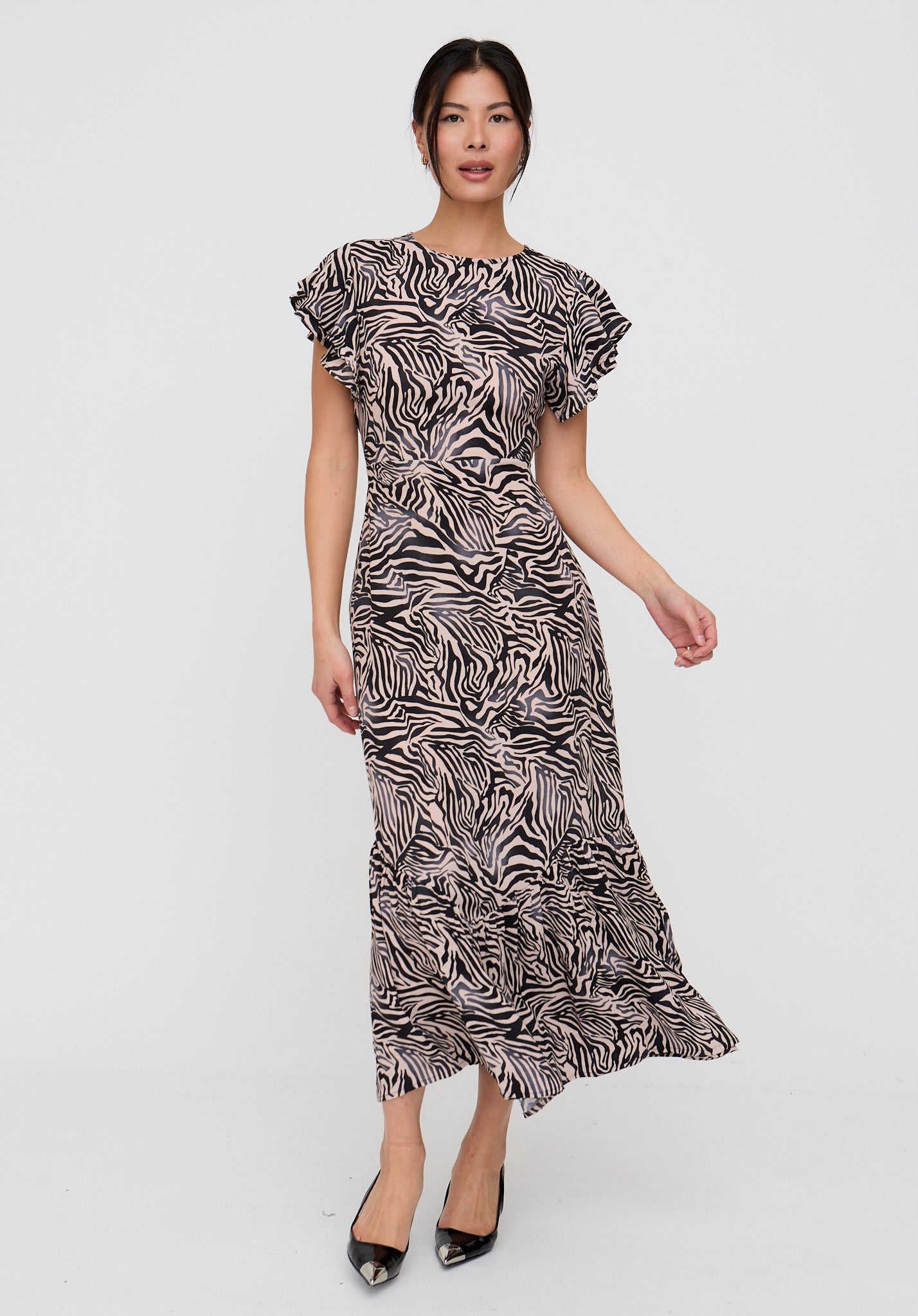 Woman wearing a zebra print dress on a white background