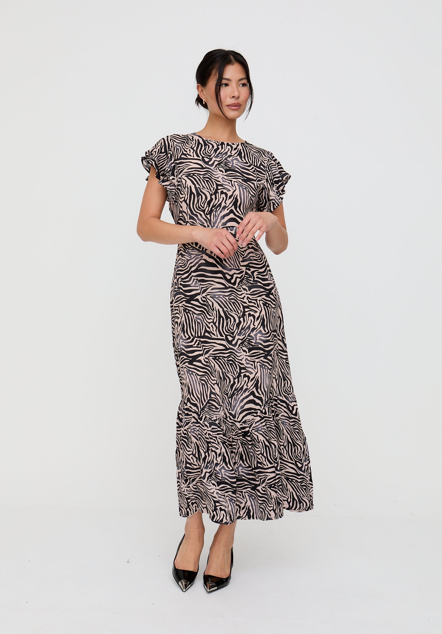 Woman wearing a zebra print dress on a white background