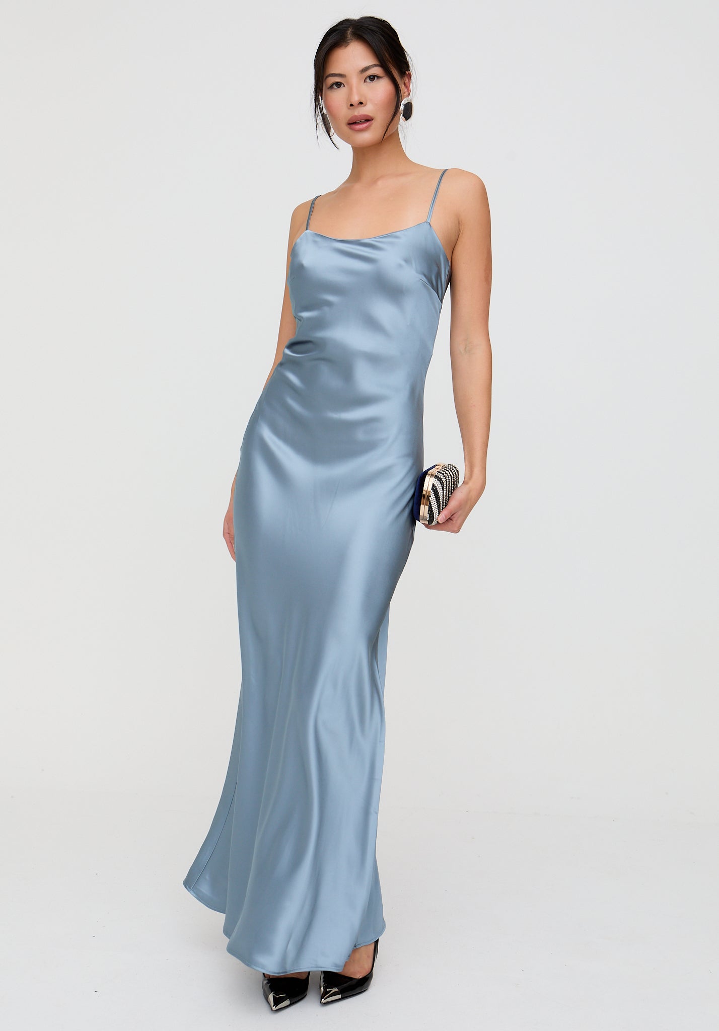 Woman wearing a light blue satin dress on a white background