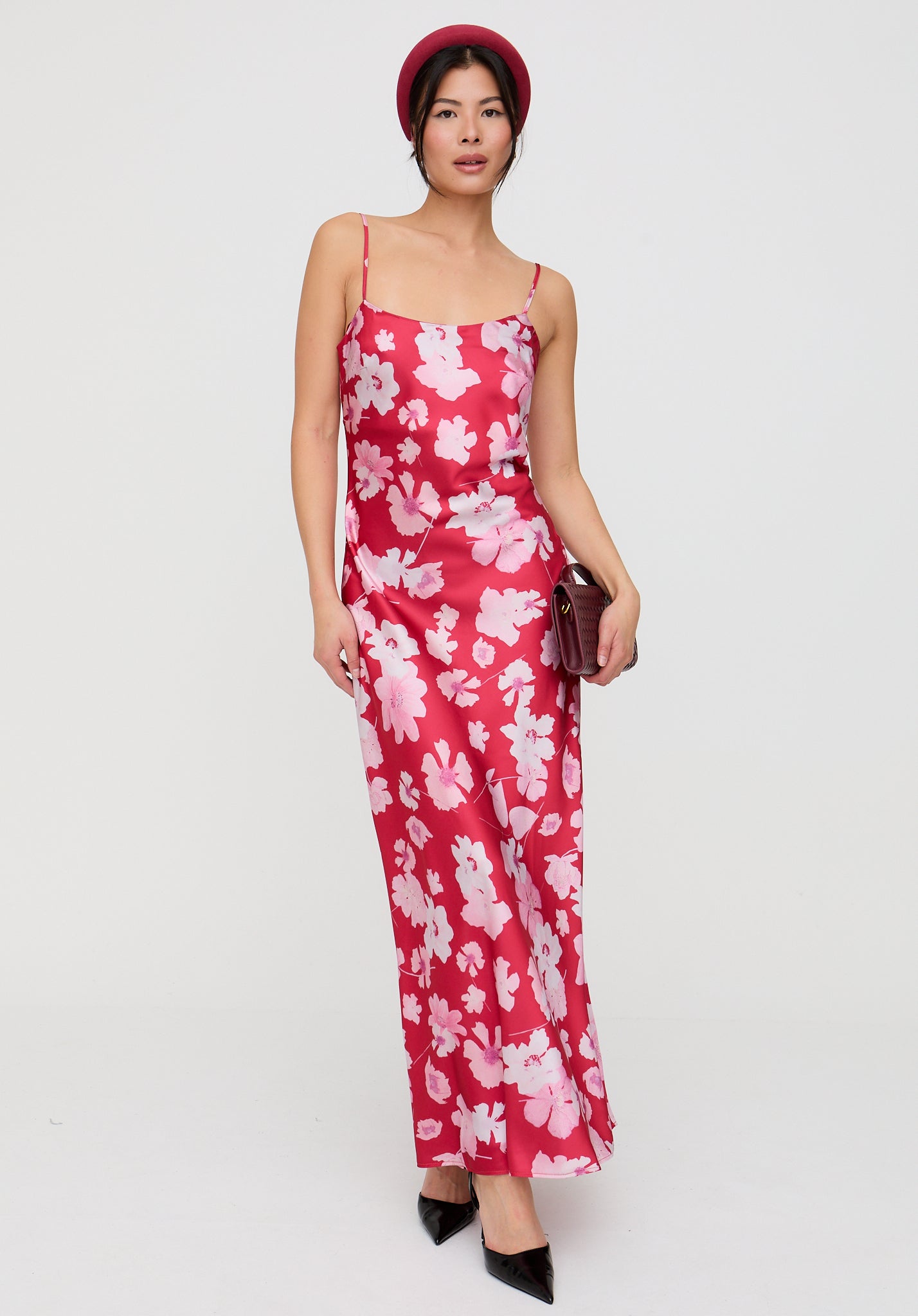 Woman wearing a red floral dress on a white background