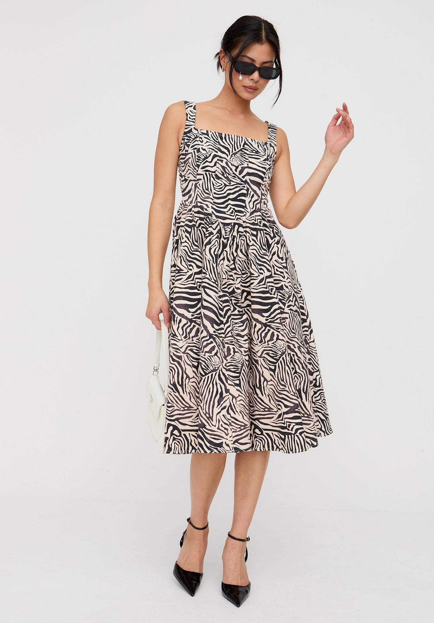 Woman wearing a zebra print dress on a white background