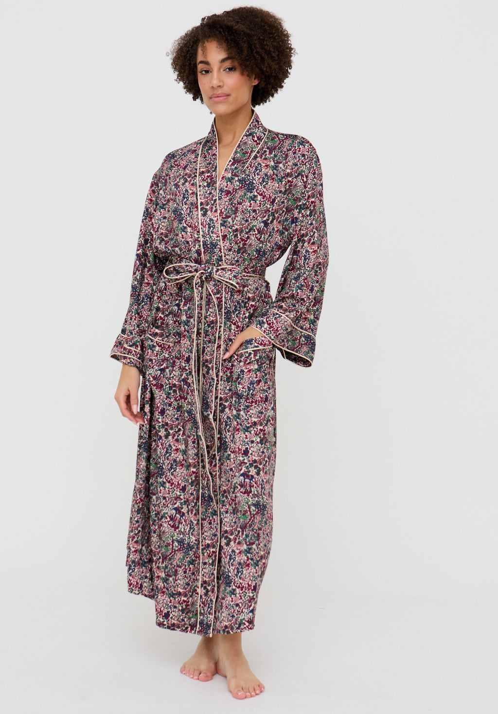Woman wearing a floral patterned robe on a white background