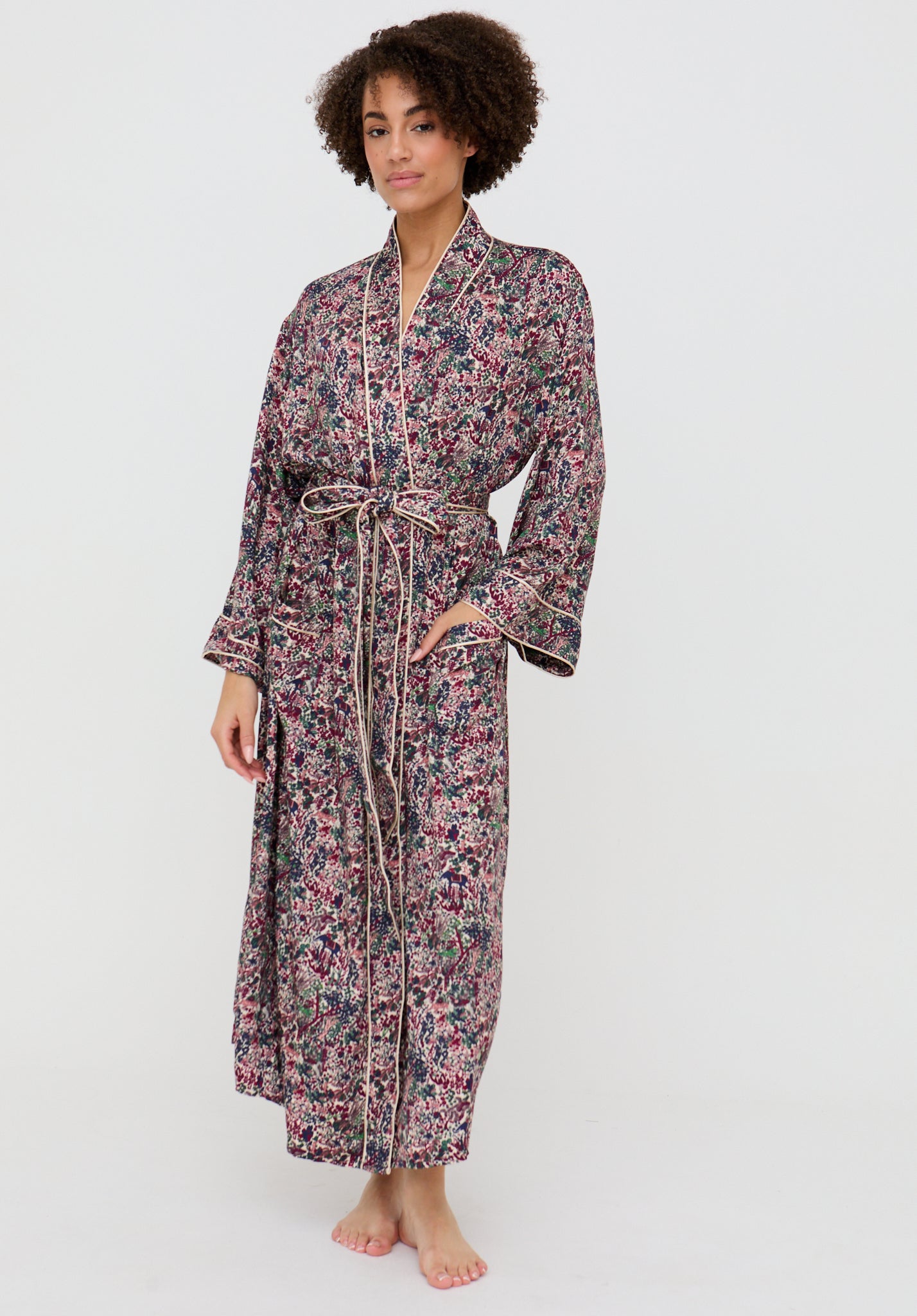 Woman wearing a floral patterned robe on a white background