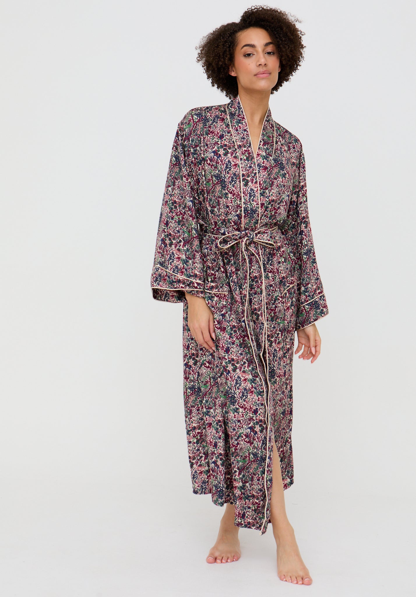 Woman wearing a floral robe on a white background