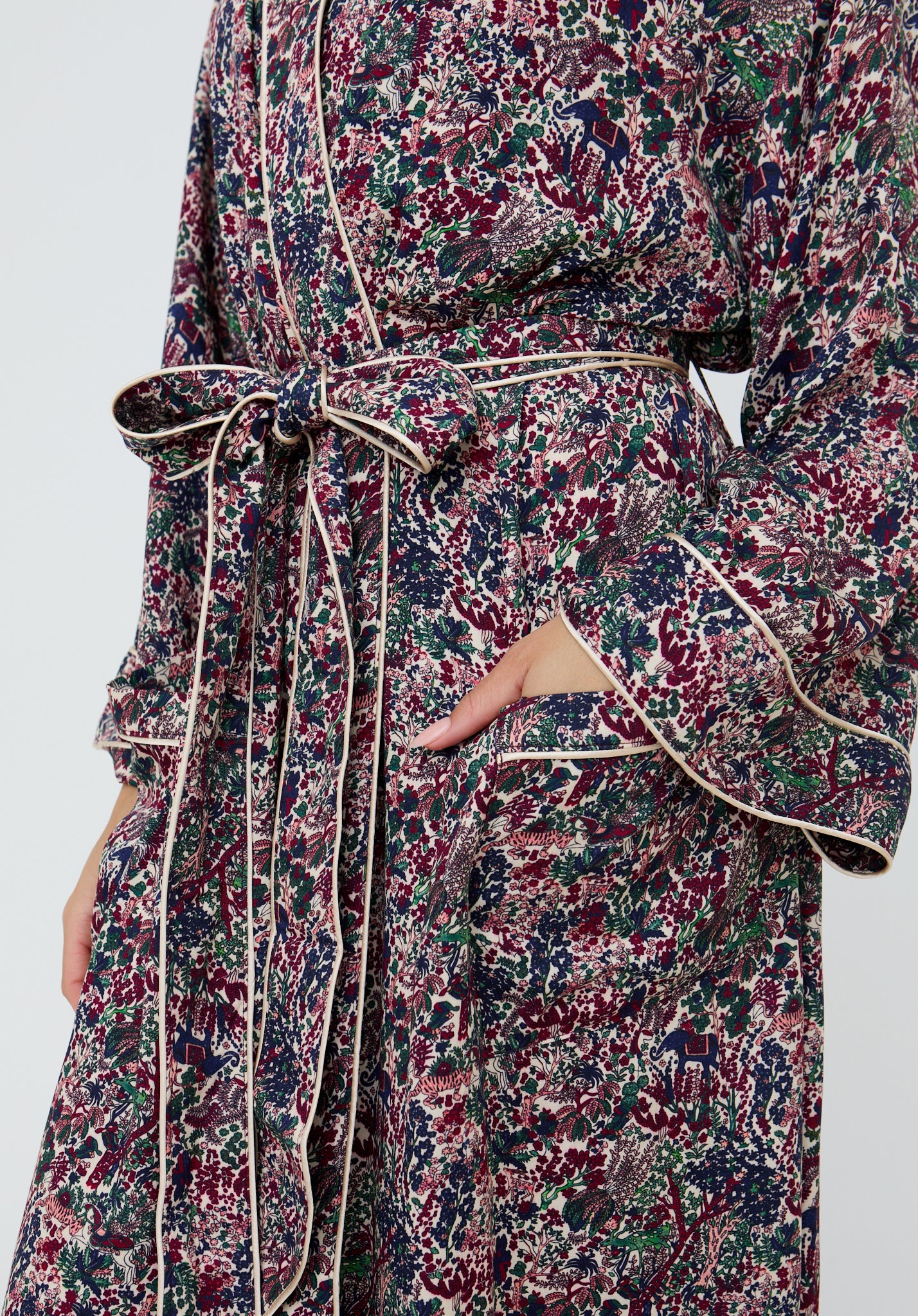 Floral patterned robe with a belt on a plain background