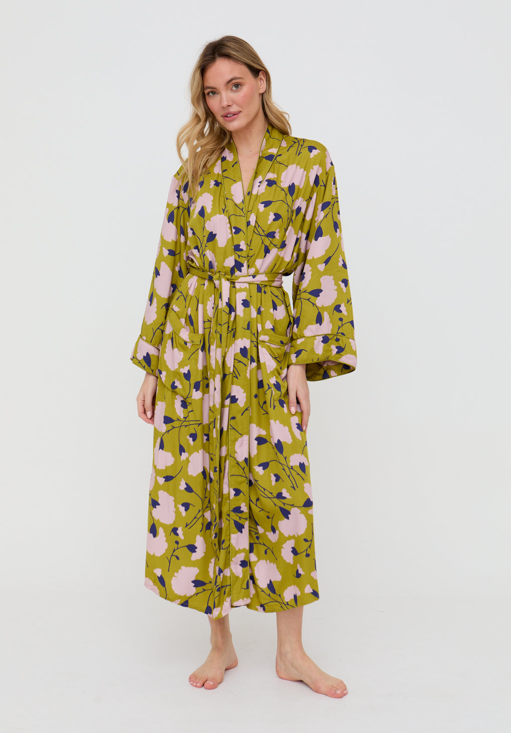 Woman wearing a floral patterned robe on a white background