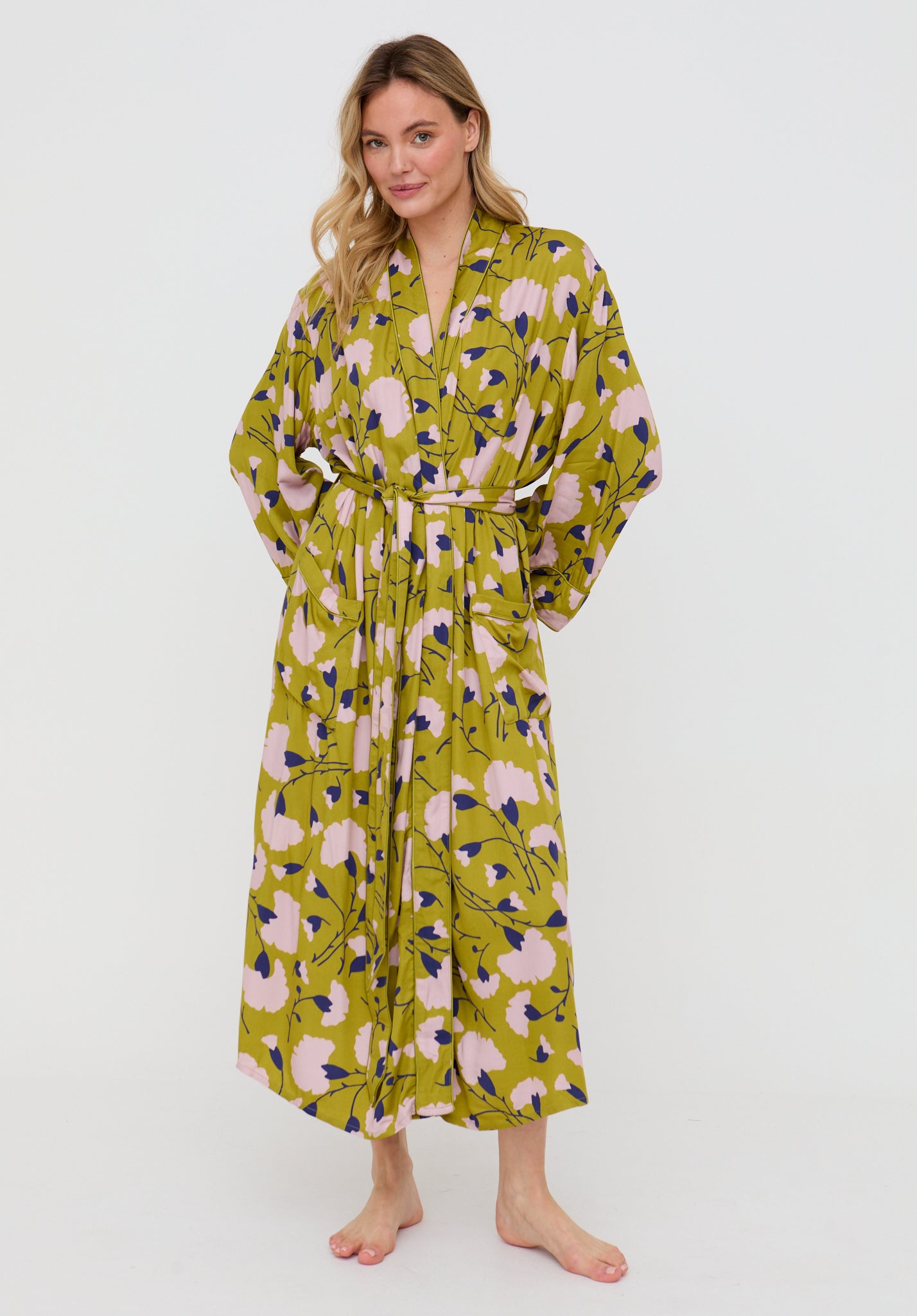 Woman wearing a green floral dress on a white background