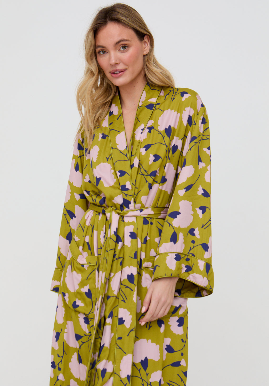Woman wearing a floral patterned robe on a white background