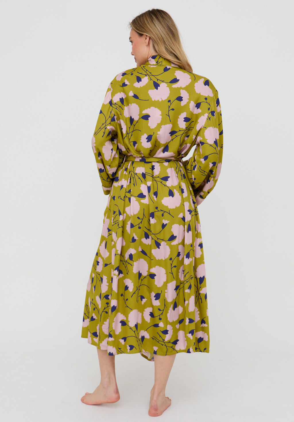 Woman wearing a floral dress with a green background