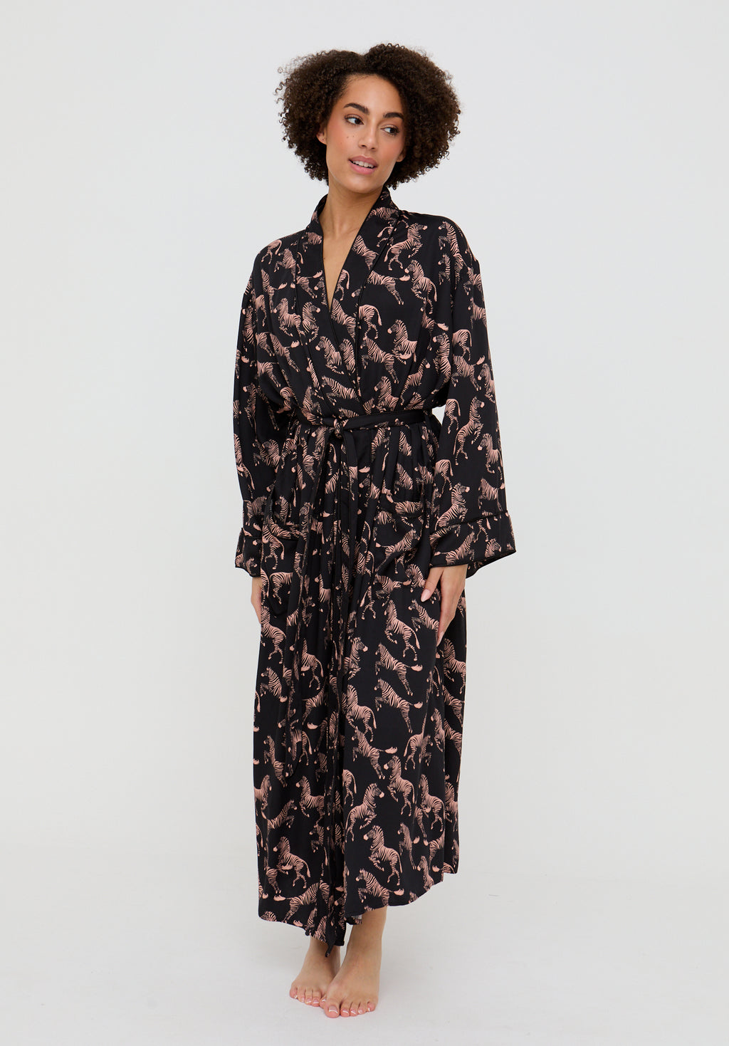 Woman wearing a long, patterned robe on a white background