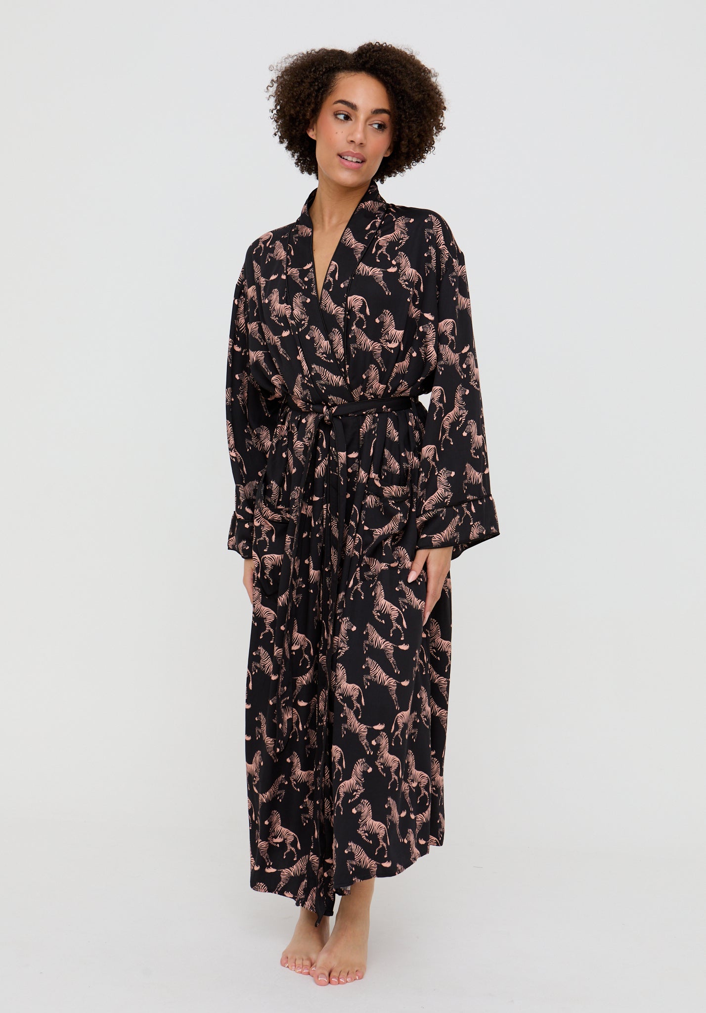 Woman wearing a long, patterned robe on a white background