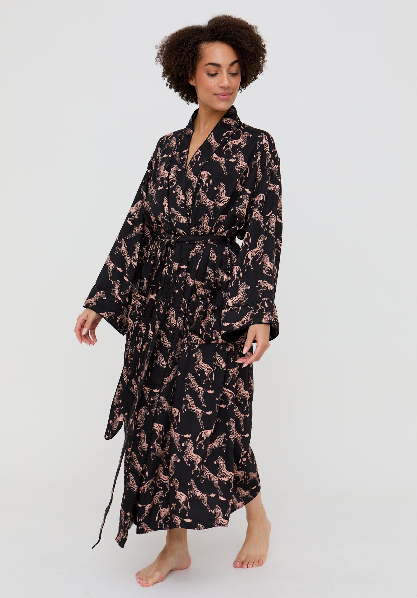 Woman wearing a black and brown patterned robe on a white background