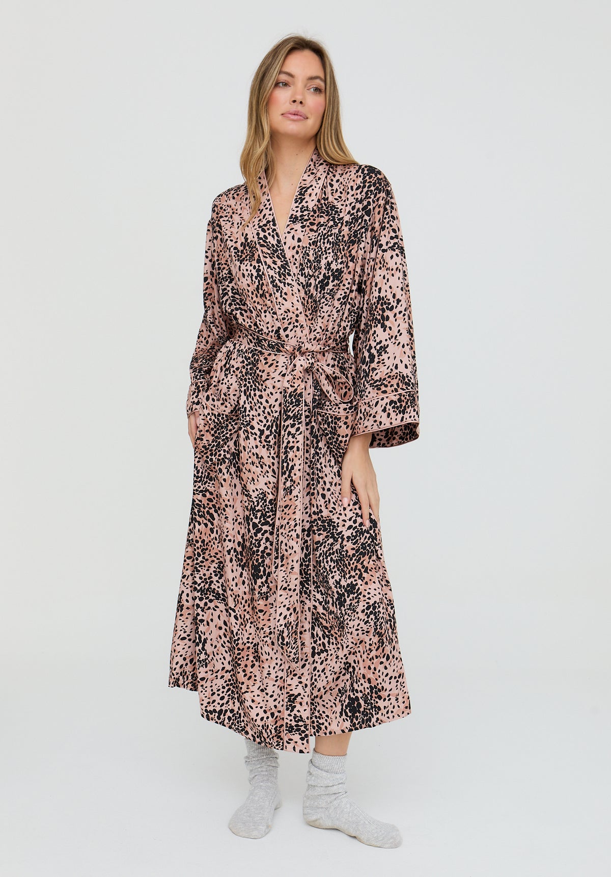 Woman wearing a patterned dress on a white background