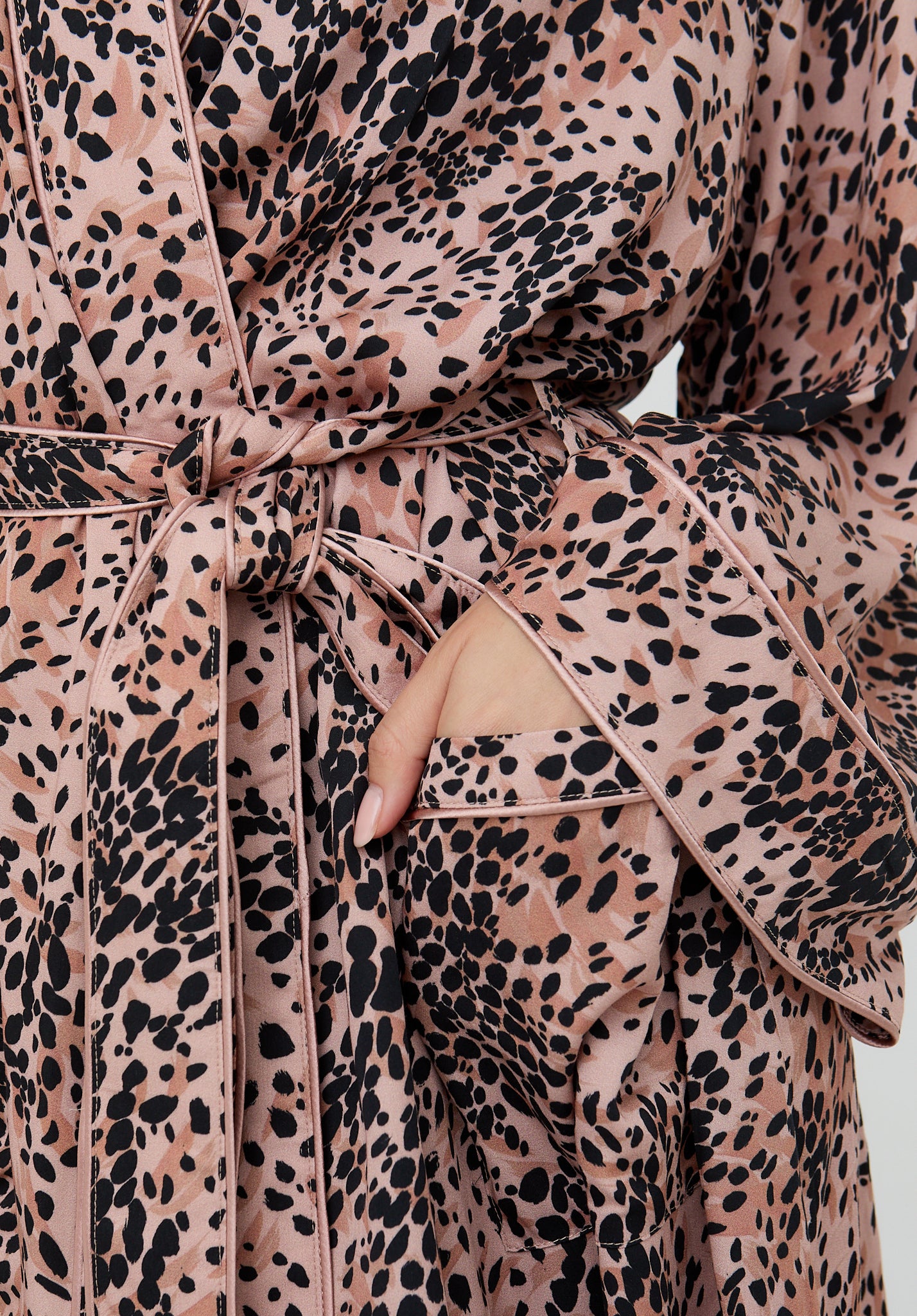 Leopard print robe with a tie waist on a plain background