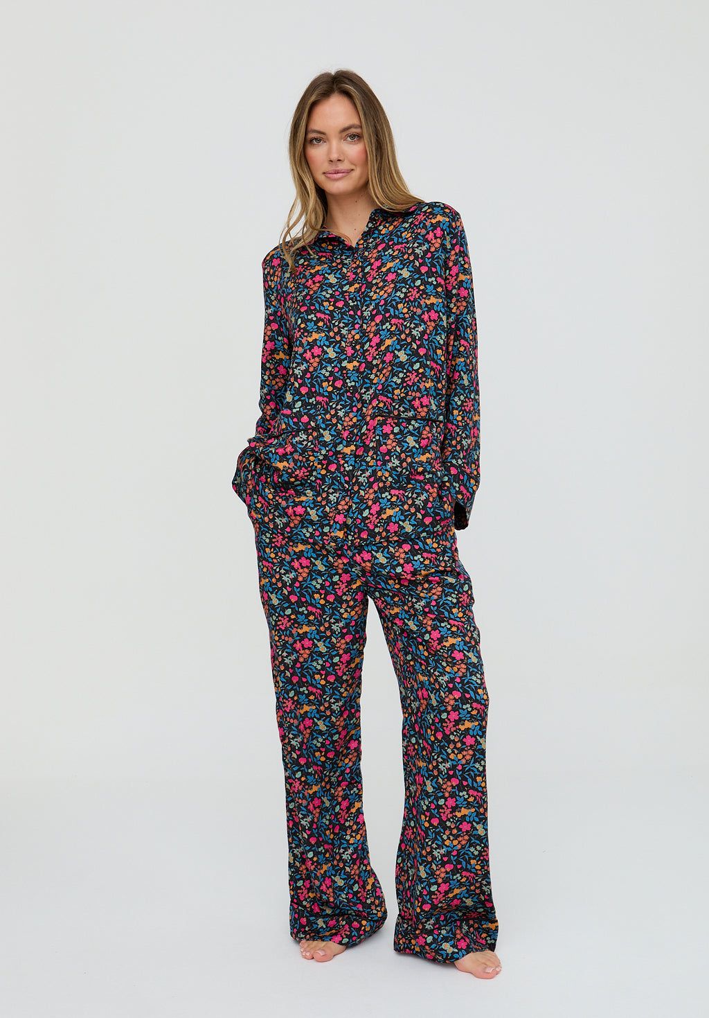Woman wearing a floral pajama set on a white background