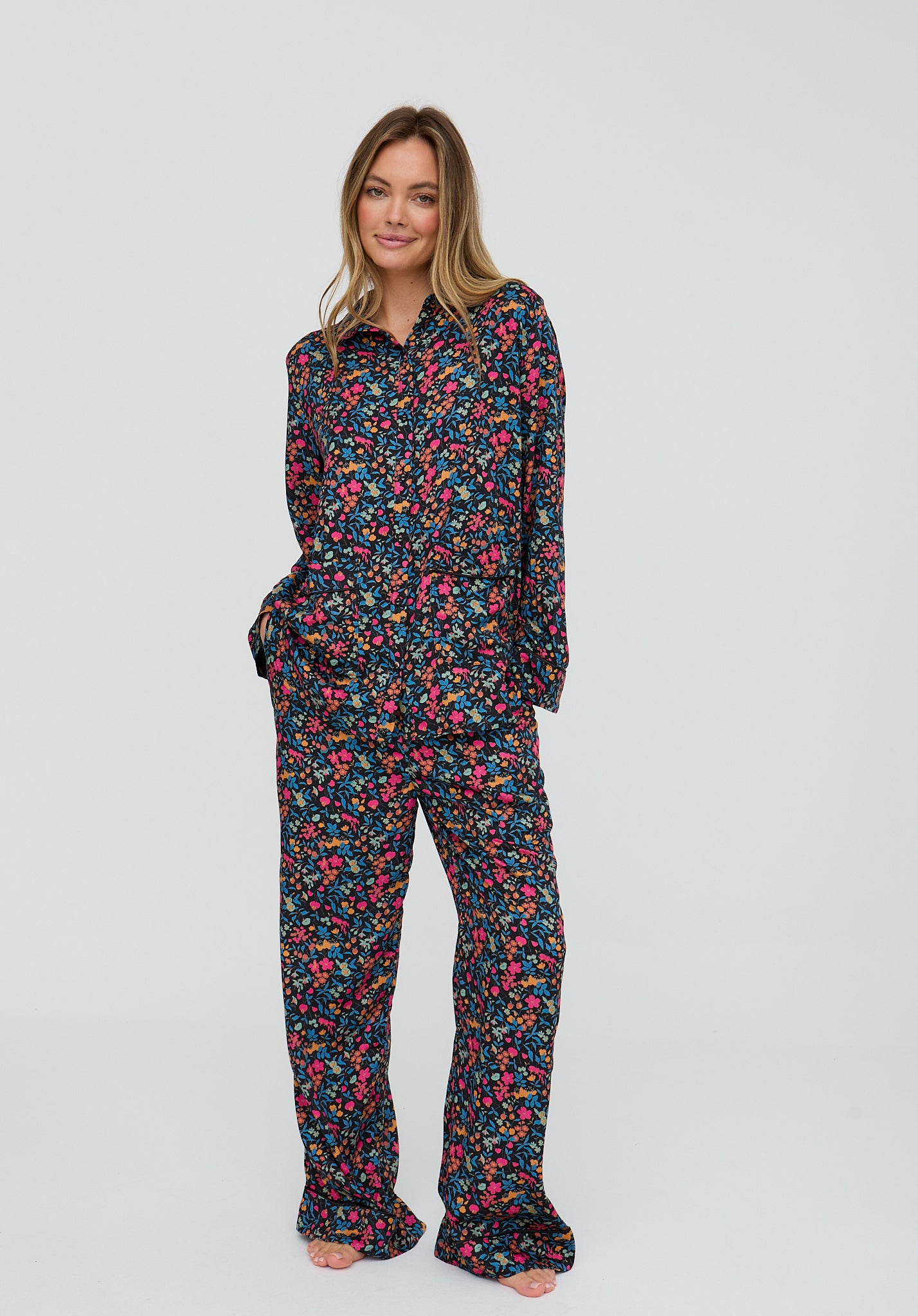 Woman wearing a floral pajama set on a white background