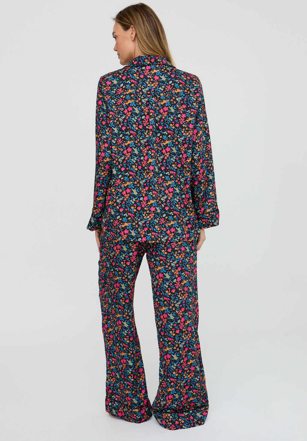 Woman wearing a floral pajama set on a white background