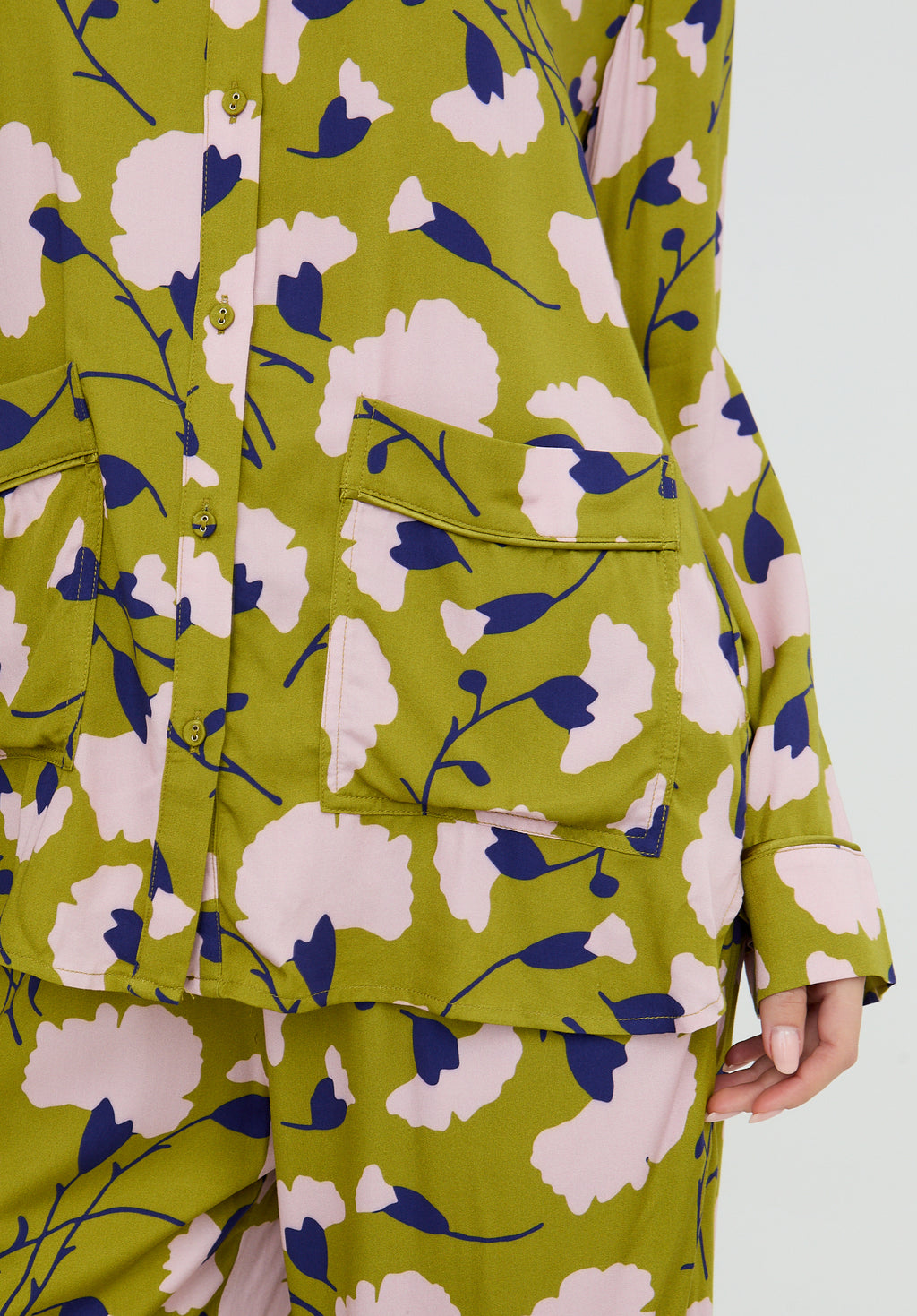 Green floral-patterned outfit on a white background