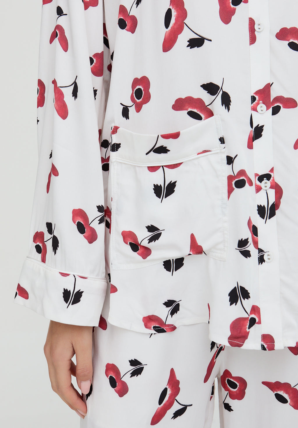 White outfit with red and black floral pattern on a white background