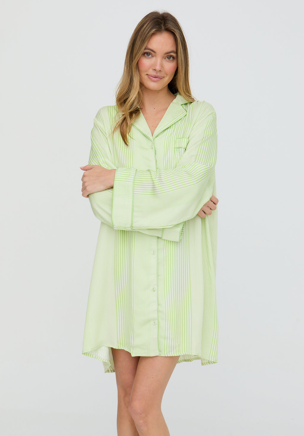 Woman wearing a light green dress with a white background