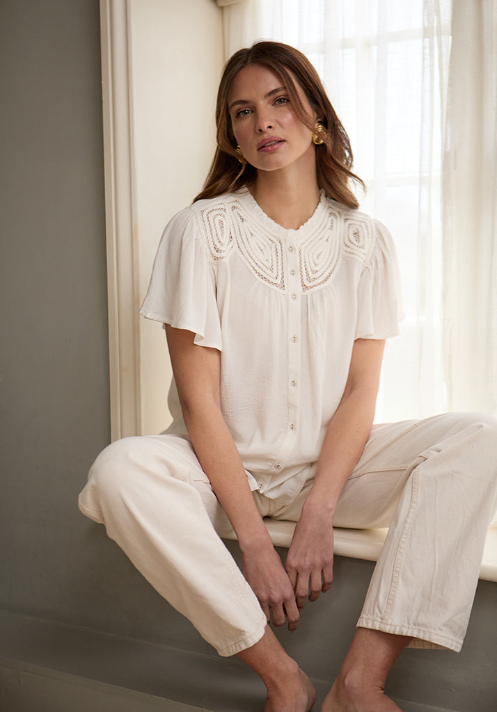 lifestyle image showing model wearing Kew Lace Insert Angel Sleeve Shirt In Cream - image 1