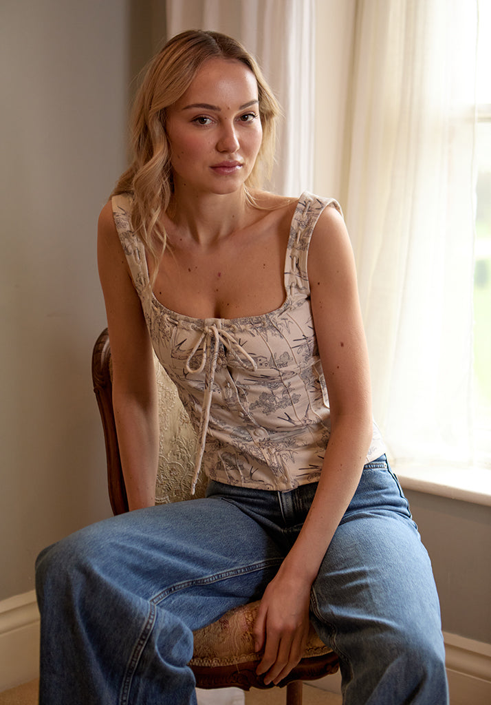 lifestyle image showing model wearing Hilda Corset Inspired Josephine Print Blouse In Cream