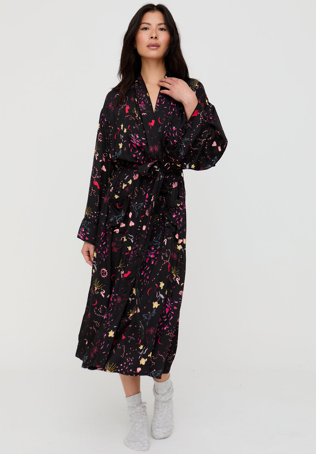 Woman wearing a black floral dress on a white background