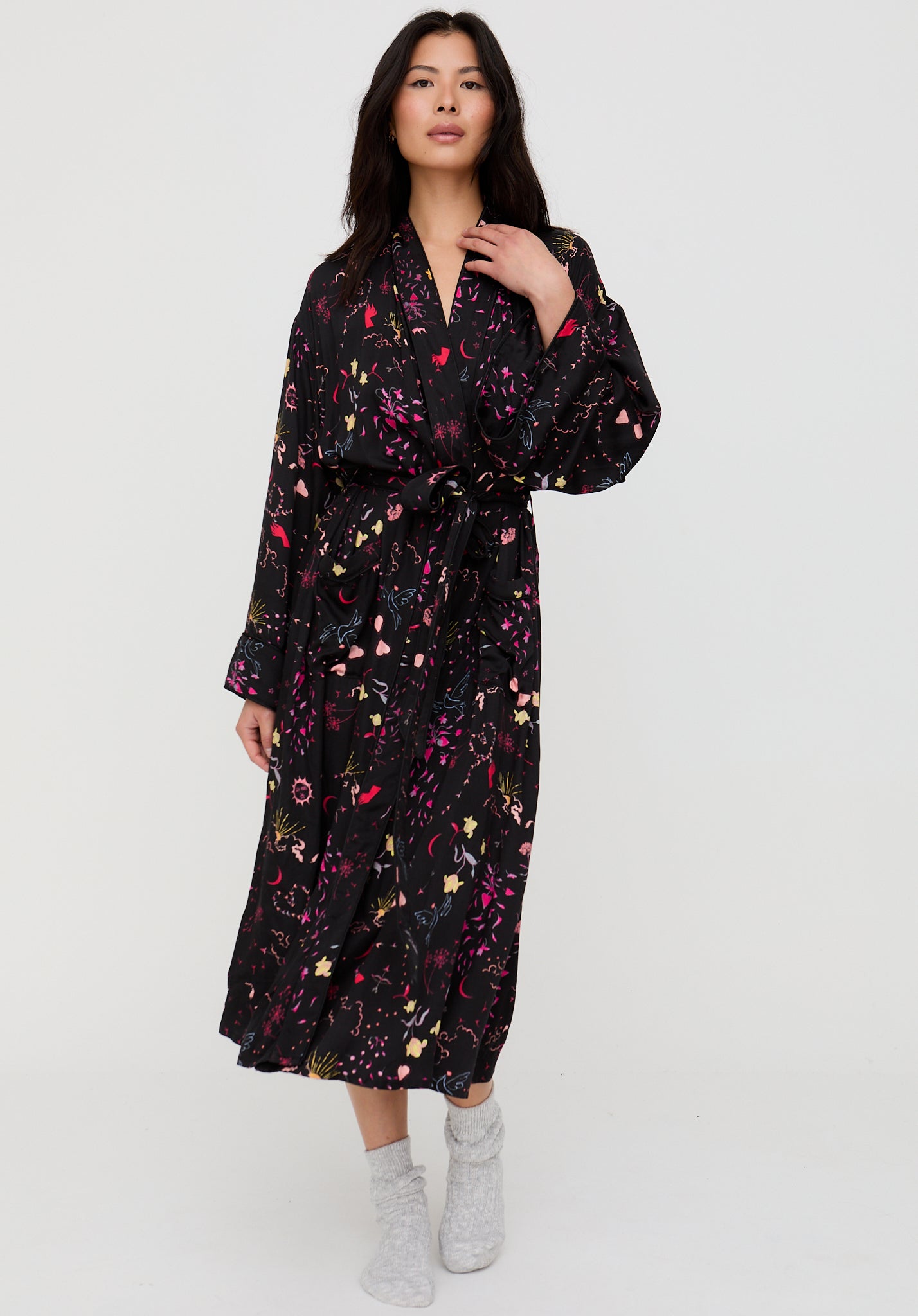 Woman wearing a black floral dress on a white background