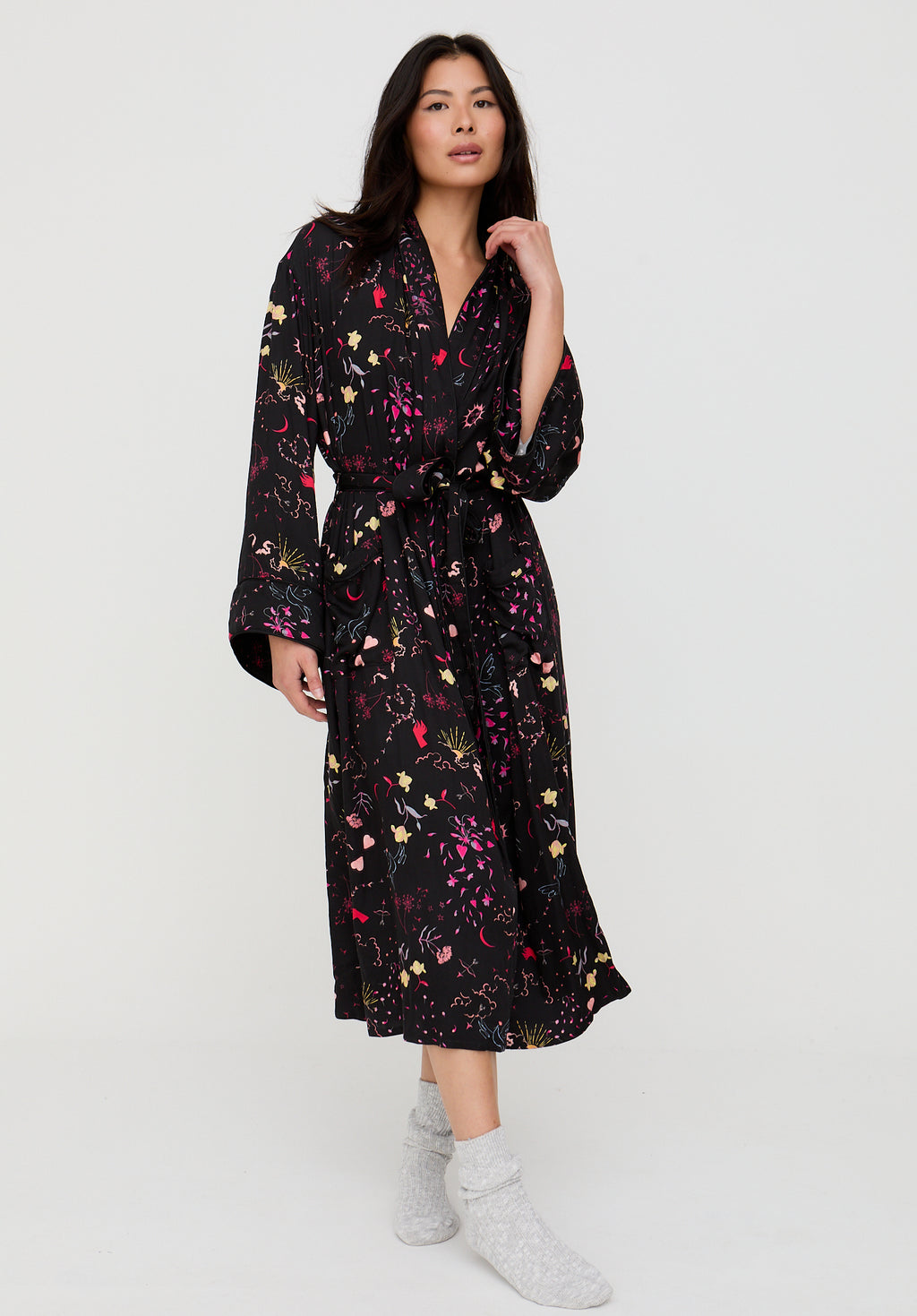 Woman wearing a black floral dress on a white background