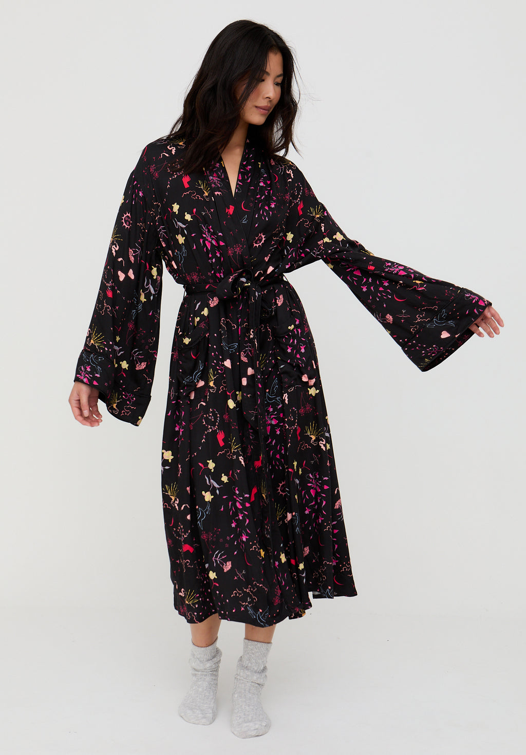 Woman wearing a black floral dress on a white background