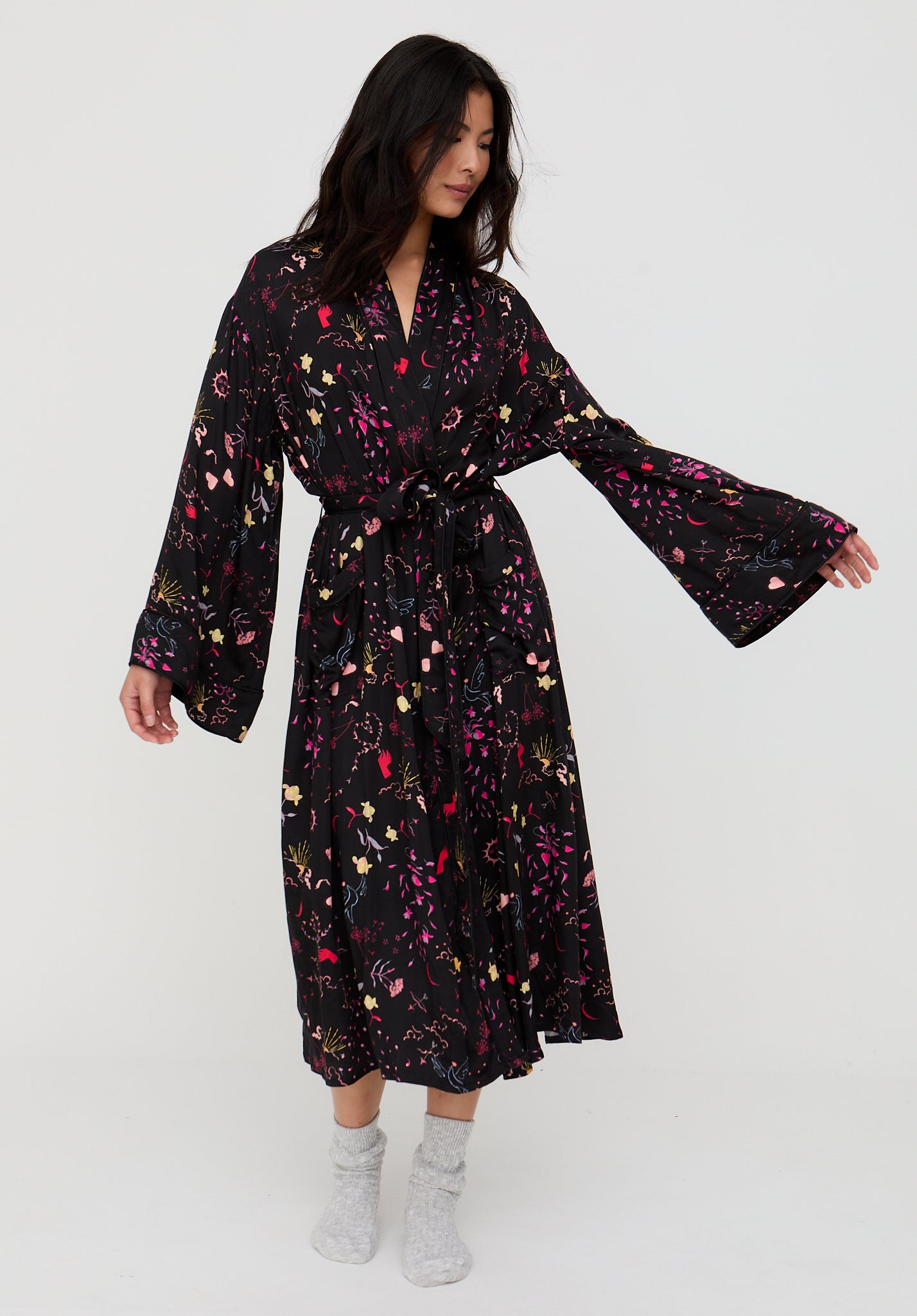 Woman wearing a black floral dress on a white background