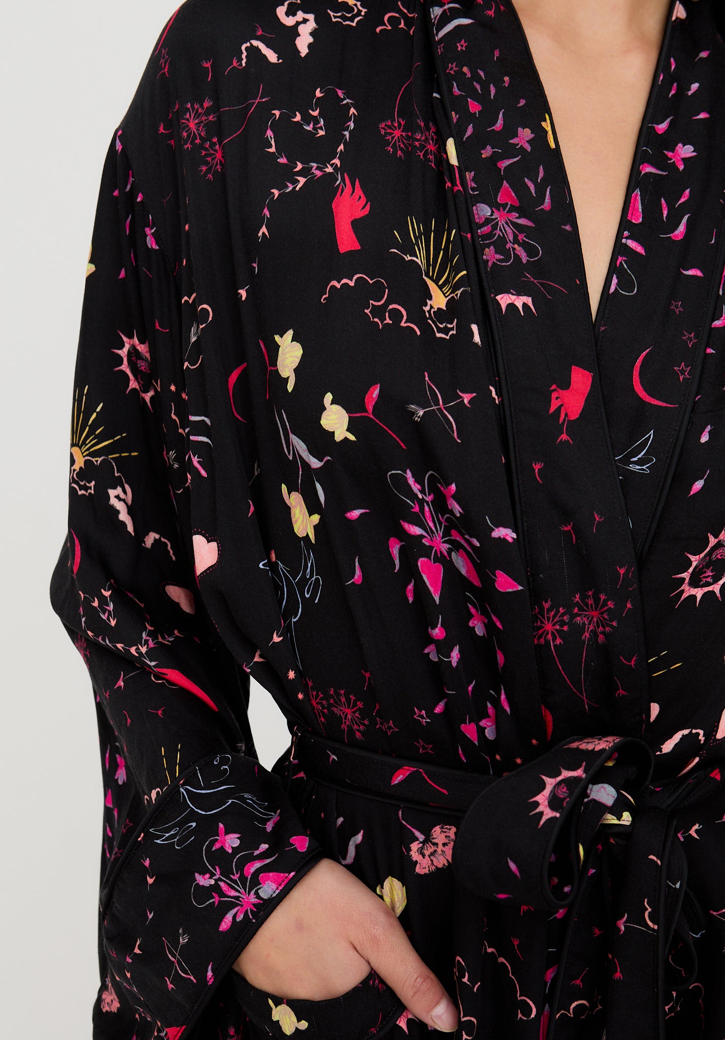 Black robe with colorful floral and abstract pattern on a white background