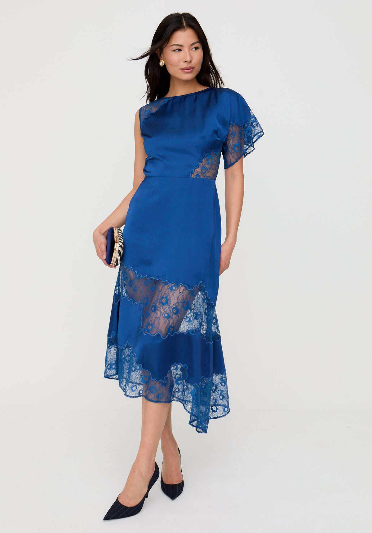 Woman wearing a blue dress with lace details on a white background