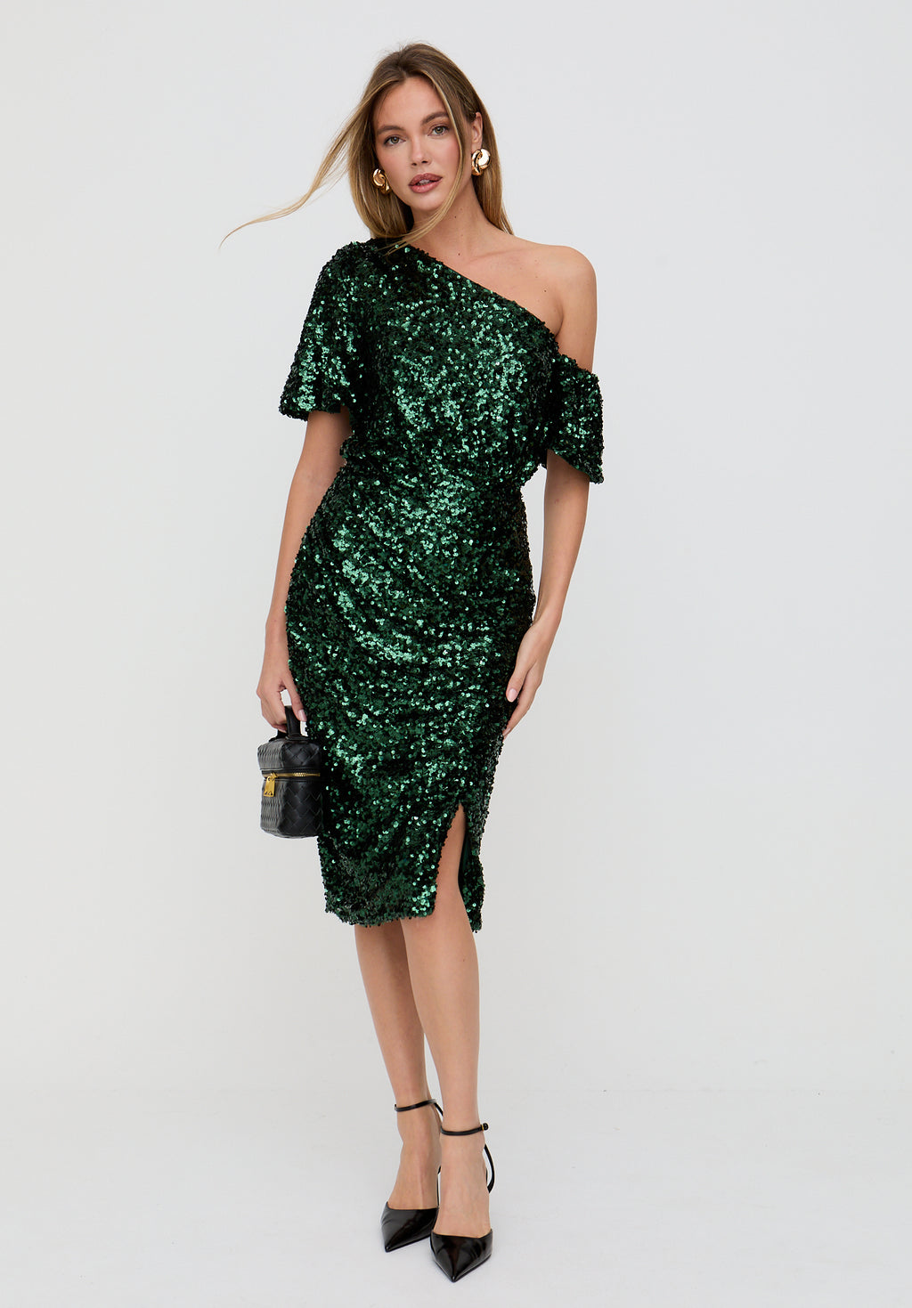Woman wearing a green sequin dress on a white background