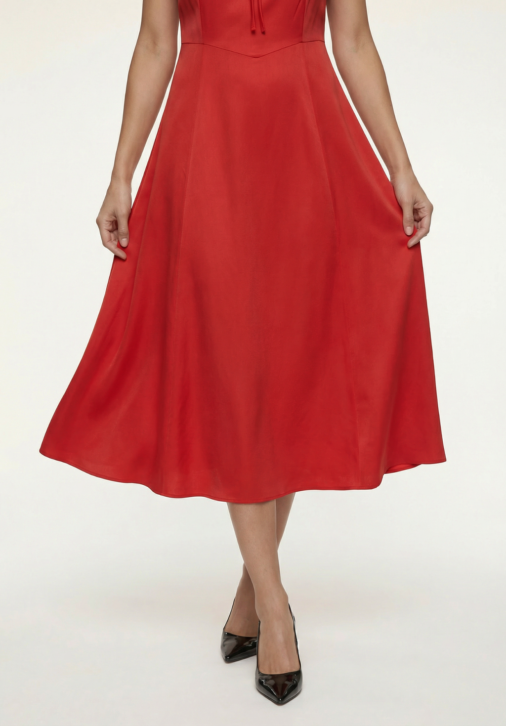 Red dress worn by a person on a white background